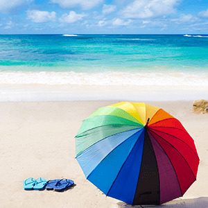 Multi-colored umbrella on beach