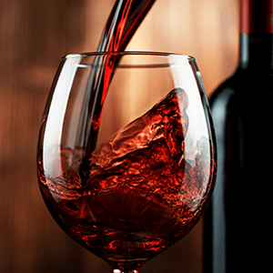 Red wine pouring into glass