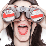 Close-up of woman using binoculars, representing marketing insight and strategic mail campaigns.