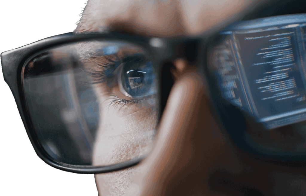Close-up of a person wearing glasses analyzing digital marketing data on a screen for direct mail campaigns.