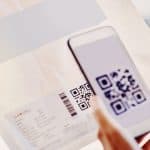 Scan QR code on direct mail piece with smartphone for innovative marketing outreach.