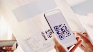 Scan QR code on direct mail piece with smartphone for innovative marketing outreach.