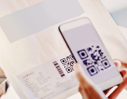 Scan QR code on direct mail piece with smartphone for innovative marketing outreach.